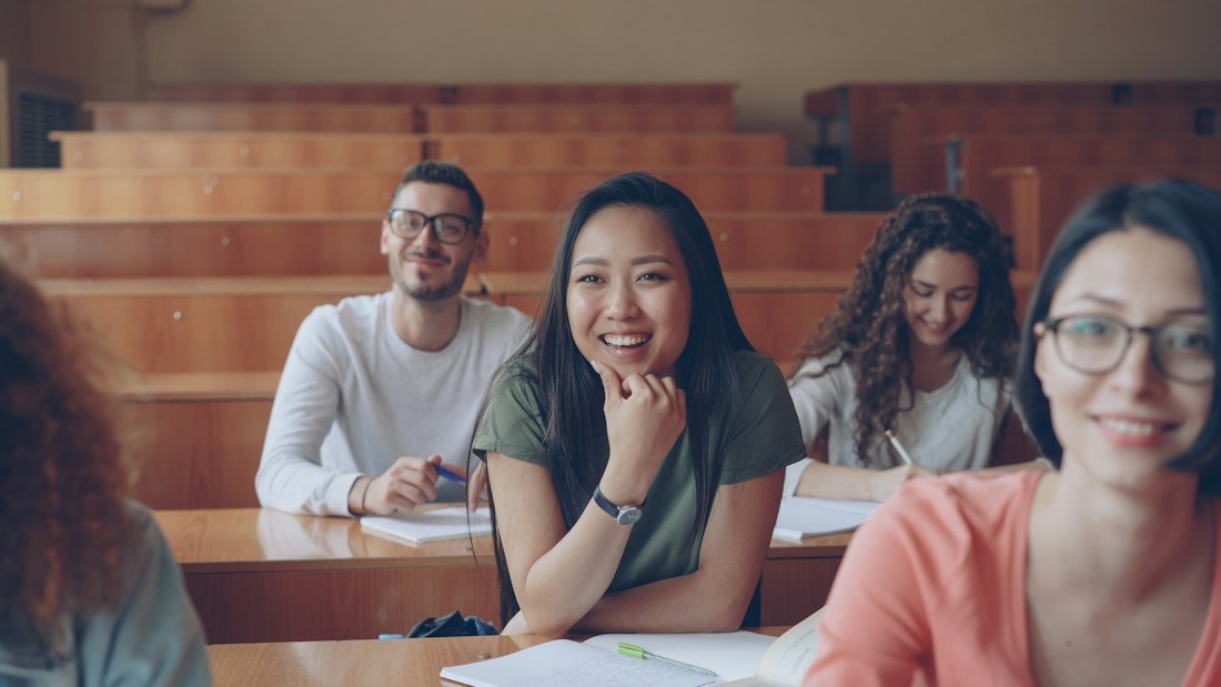 Des étudiants souriants dans un amphithéâtre